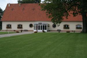 a building with a green lawn in front of it at Le Blockhaus de Domléger et Spa in Domléger