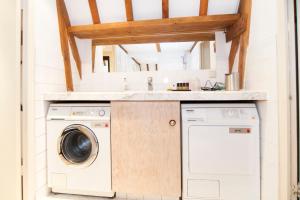 a laundry room with a sink and a washing machine at Bed & Breakfast of Art in Amsterdam