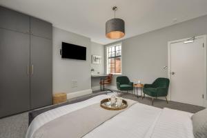 a bedroom with a bed and a table and chairs at Cuckoo Rooms in Colchester