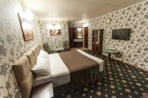 a hotel room with a bed and a television at Отель Наутилус in Pyatigorsk