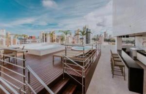 a rooftop deck with a view of a city at Manaíra Apart Hotel in João Pessoa
