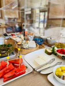 a table with plates of food on a table at Hotel Doro in Burgas City