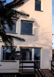 a white building with windows and a satellite at Marymont in Warsaw