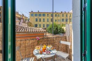 a table with food and drinks on a balcony at MY CASA - 10 CASSINI in Nice