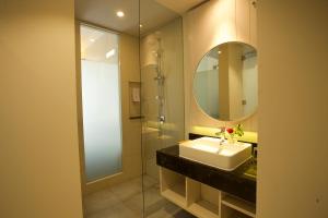 a bathroom with a sink and a mirror at Swiss-Belinn Cikarang in Cikarang