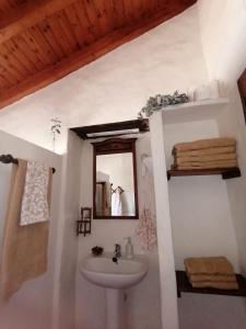 uma casa de banho com um lavatório e um espelho em Vv LOS SENDEROS FONTANALES em Moya