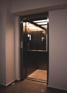 an open door into a hallway with a mirror at Dream Arena Apartment in Bacău +33 photos