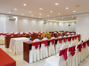 a conference room with tables and chairs with red bows at Thanh Van Hotel Quy Nhon in Quy Nhon