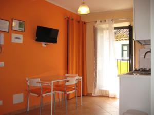 a kitchen with a table and chairs and a window at Gaia Holidays in Cefalù