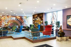 um átrio com cadeiras coloridas num edifício em Tivoli Hotel em Copenhaga