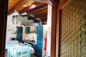 a kitchen with a table and a dining room at In the heart of Verona in Verona
