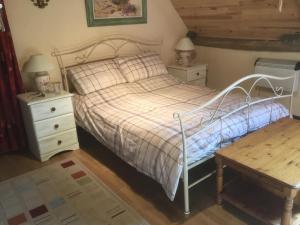a bedroom with a bed and two night stands at La Bellangerie in Colombiers-du-Plessis