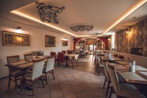 a restaurant with tables and chairs in a room at Ferdinand Penzion in Moldava nad Bodvou