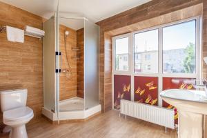 a bathroom with a shower and a toilet and a sink at Marton LIDER Krasnodar in Krasnodar