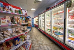 an aisle of a grocery store with food at Apartments DIEM in Samokov