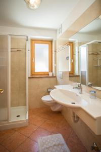a bathroom with a sink and a toilet and a shower at Appartamenti Alba in Livigno