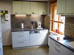 a kitchen with white cabinets and a counter top at Ferienwohnung Auszeit in Bietigheim-Bissingen