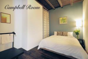 a bedroom with a bed with a white bedspread at Carnarvon House in George Town