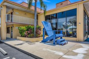 a blue chair in front of a building at Rodeway Inn Port Richey North in Port Richey