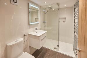 a bathroom with a toilet sink and a shower at Host & Stay - Staffordshire Hideaway in Whitby