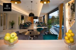 a dining room with tables and chairs and a cafeteria at Hotel Amicus in Mostar