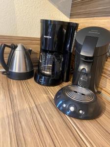 a coffee maker and a blender sitting on a table at Ferienwohnung auf Rügen mit Boddenblick in Groß Zicker