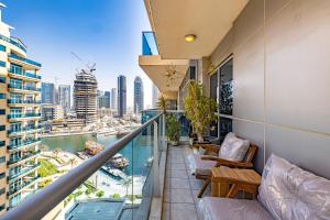 an apartment balcony with a view of the city at Large 2 Beds Partial Marina View, J Tower II in Dubai