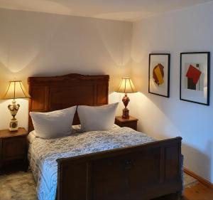 a bedroom with a bed with two lamps on two tables at Schloss Stülpe in Stülpe