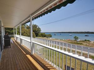 a porch of a house with a view of the ocean at Riverwatch in Hawks Nest