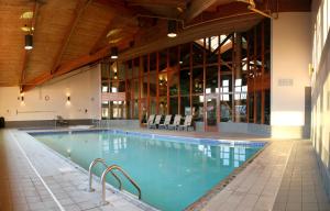 a large swimming pool in a large building at C'mon Inn Grand Forks in Grand Forks