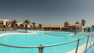 a large swimming pool in a resort at Castillo Sol Bungalow in Caleta De Fuste