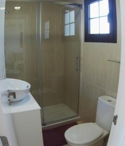 a bathroom with a shower and a toilet and a sink at Castillo Sol Bungalow in Caleta De Fuste