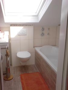 a bathroom with a toilet and a tub and a sink at Fewo-Nescht in Vaihingen an der Enz