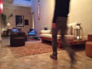 a person walking through a living room with a couch at Dar Les Sirènes in Essaouira