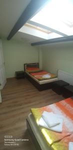 a room with two beds and a ceiling at Apartments DIEM in Samokov