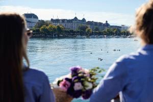 two people standing on a boat in the water at Hotel Europe in Zurich