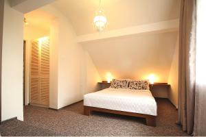 a bedroom with a bed and a chandelier at Anka in Władysławowo