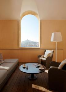 a living room with a couch and a table at InterContinental Marseille - Hotel Dieu by IHG in Marseille