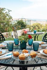 a table topped with plates filled with donuts at B&B Gli Archi in Abbadia San Salvatore