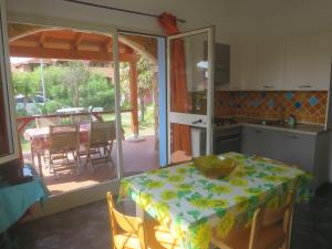 a kitchen with a table with a table cloth on it at Iocchedda in Porto Ottiolu
