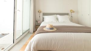 a bedroom with a bed with a hat on it at Souto Apartments in Porto