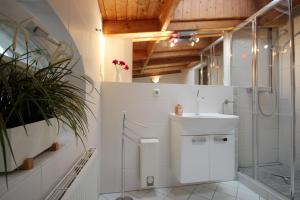 a white bathroom with a sink and a shower at Villa Jugendglück by Rujana in Binz