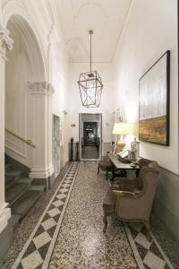 a hallway with a table and chairs in a building at Palazzo Lorenzo Hotel Boutique & Spa in Florence