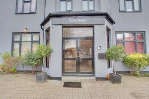 a store front with a glass door on a building at Civic Hotel in Hounslow