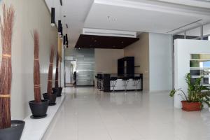 a hallway with potted plants in a building at Code Housing - Fintas - family only in Kuwait