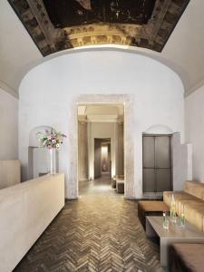 a living room with a couch and tables and a ceiling at Hotel dei Barbieri in Rome