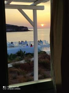 a view of the ocean from a window at Sunset Studios & Rooms in Antiparos