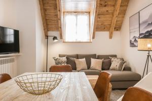 a living room with a table and a couch at Mike by Totiaran in Baqueira-Beret