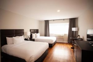 Postel nebo postele na pokoji v ubytování Hotel Newstar Montréal