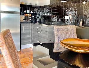 a kitchen with a stainless steel refrigerator and a counter at Herdade Monte Do Sol in Aljezur